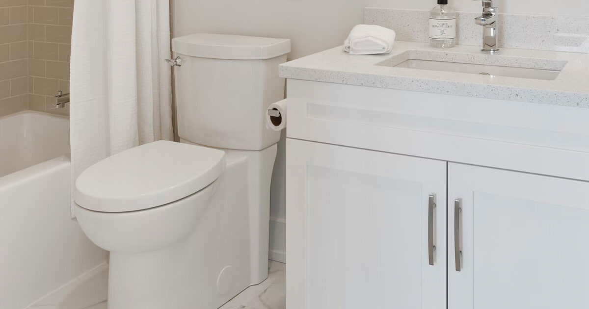 White, modern bathroom vanity, toilet, and bathtub/shower combo.